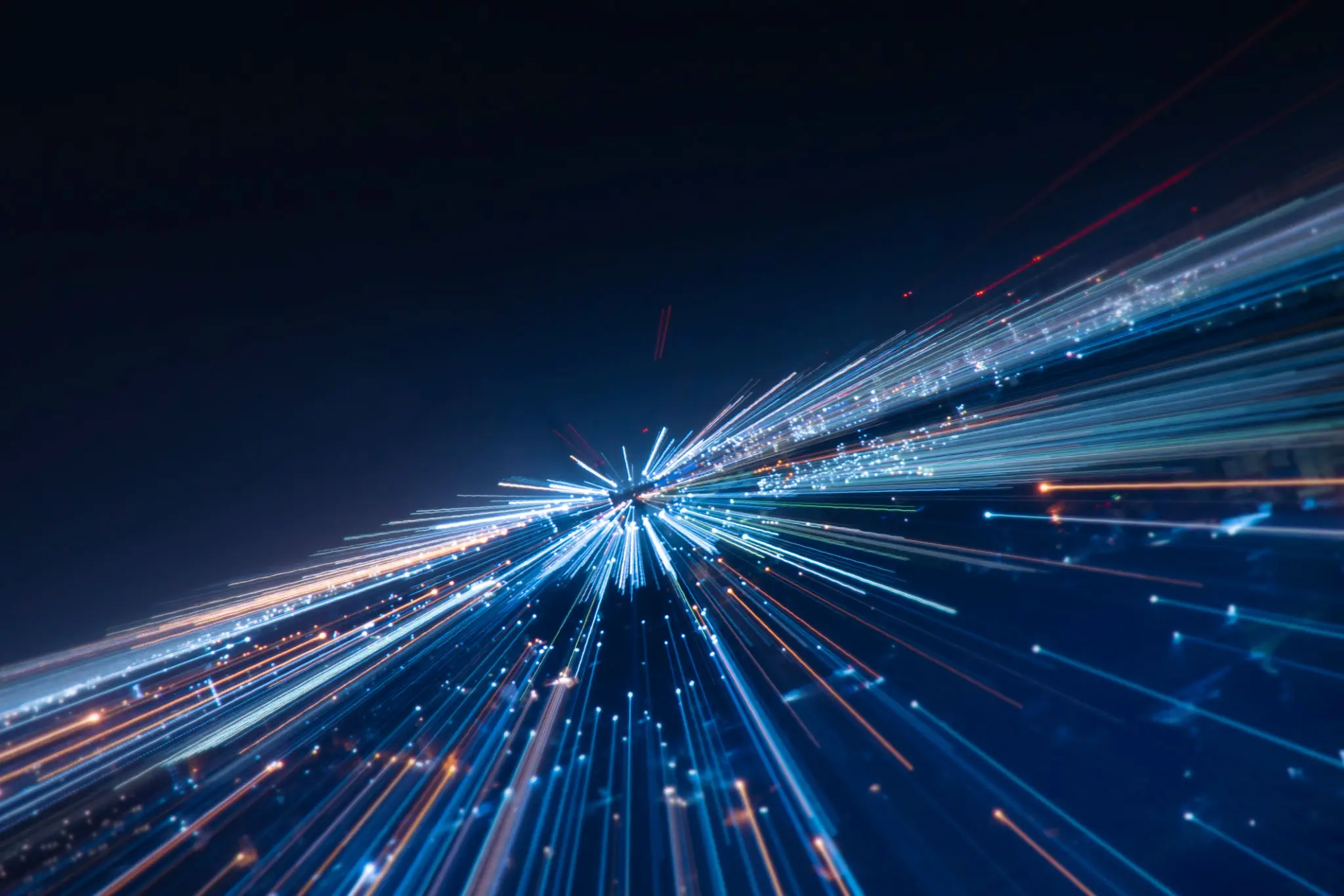 Abstract light streaks creating a dynamic, futuristic effect against a dark background.