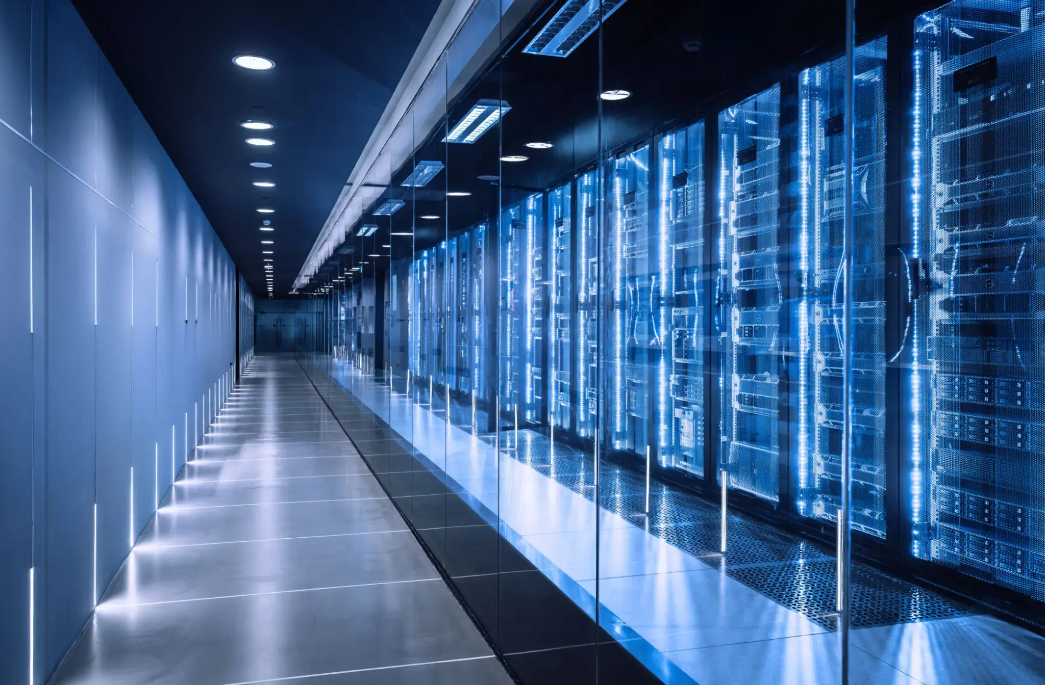 A sleek corridor with illuminated server racks in a data center.