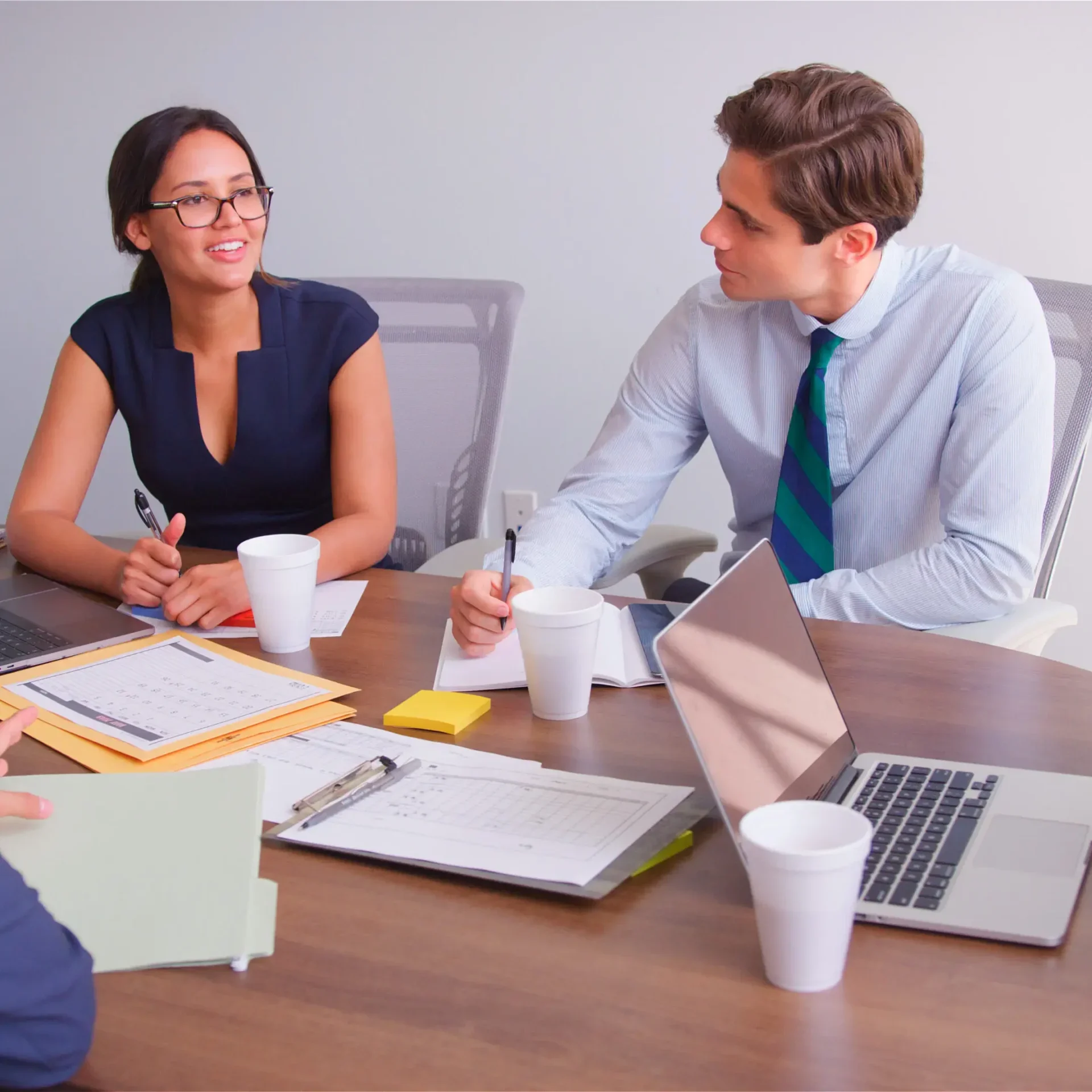 Two coworkers collaborating at office conference table