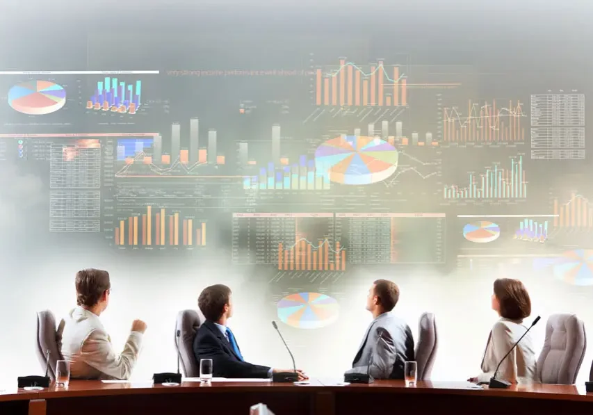 Business meeting with digital data projections in the background.